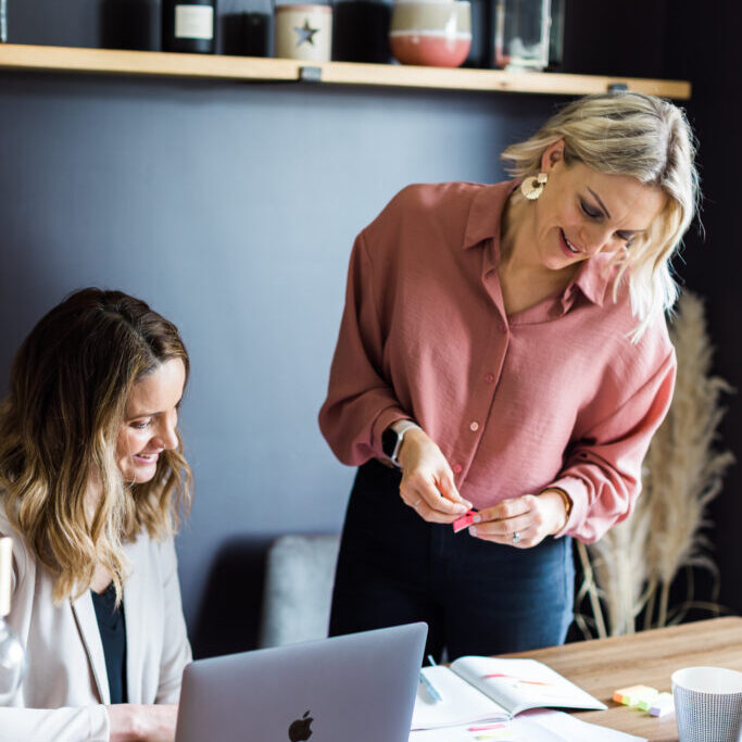 Kellie and friend collaboratively working on a project