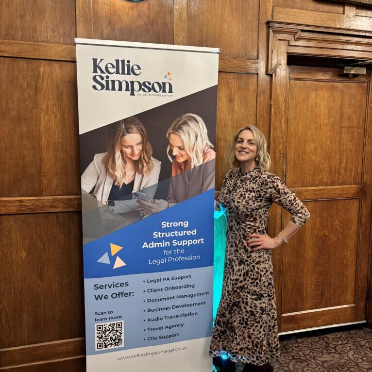 Kellie at Adviserly event in dress with her banner