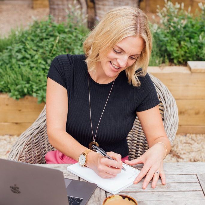 Kellie-Simpson-VA-Virtual-Assistant-Legal-Support-Web-275 Kellie sat at table writing in notebook - keeping track of key dates